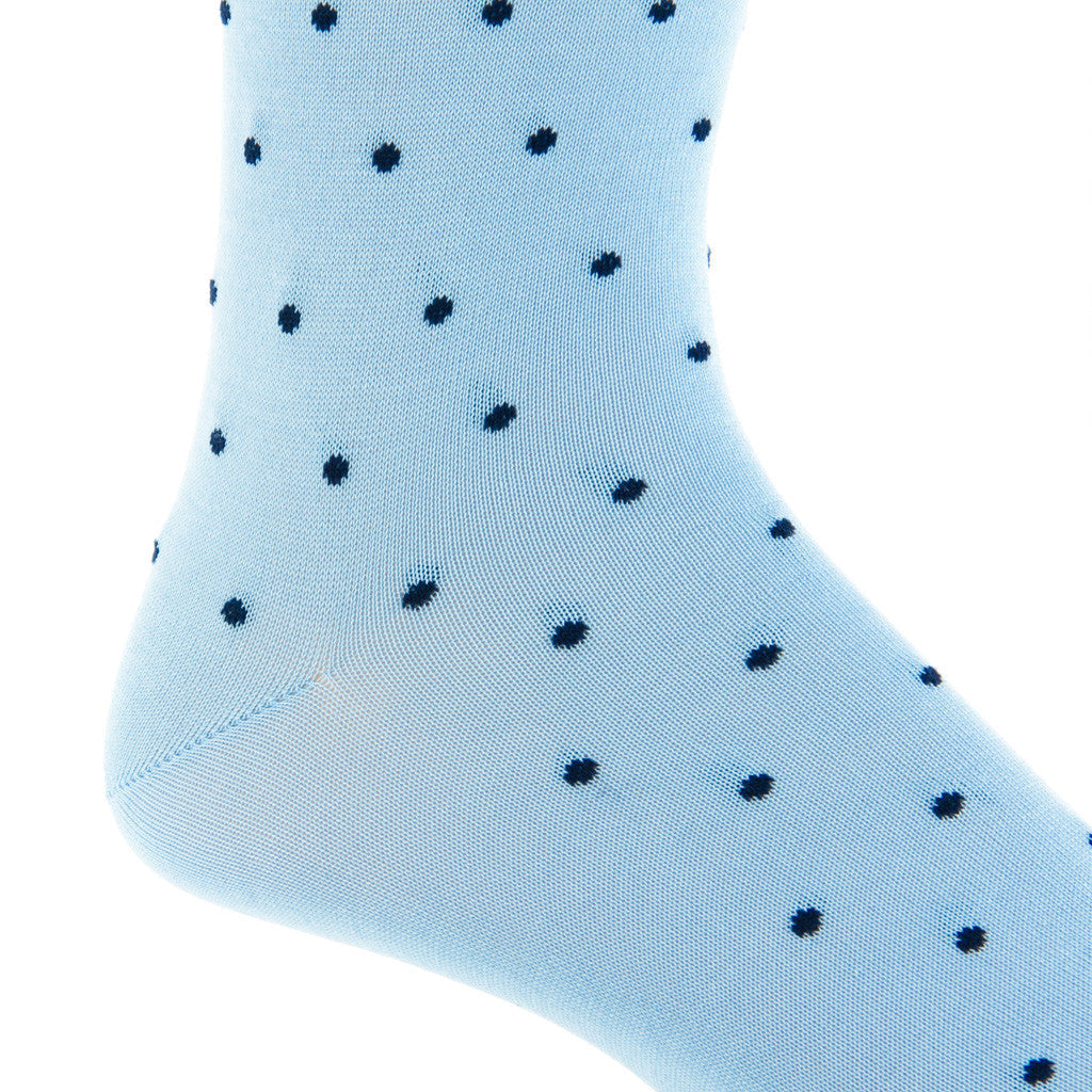 The Dapper Classics Dot Mid Calf Socks showcase a light blue design adorned with small navy blue polka dots, made from luxurious mercerized cotton for a comfortable fit.