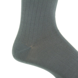Close-up of the Dapper Classics Steel Gray Solid Ribbed Cotton Sock with a linked toe, shown worn on a foot at mid-calf height, highlighting the ankle and heel against a white background.