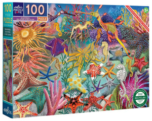 The Eeboo "Seahorses, Sea Stars & Sea Slugs 100 Piece Puzzle" features a colorful illustrated underwater scene with coral, fish, sea stars, sea slugs, and a seahorse.
