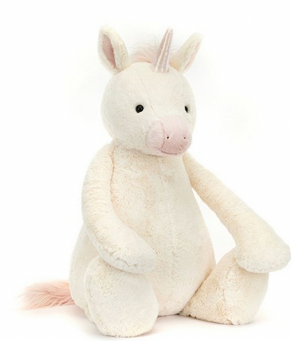 A Jellycat Bashful Unicorn, Giant with vanilla fur, a pastel pink muzzle, ears, and mane, and a holographic horn sits upright.