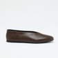 The Proenza Schouler Tee Ballet Flats, crafted in plain brown nappa leather with a black sole, are displayed against a white background.