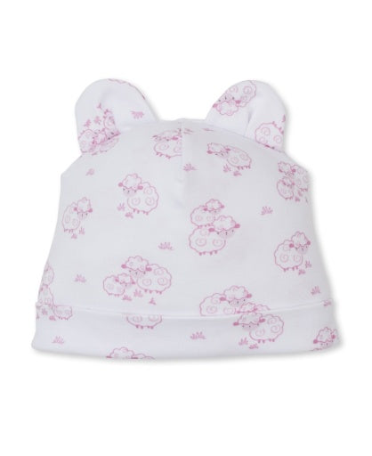The Kissy Kissy Sweet Sheep Hat is a soft white baby hat crafted from premium Pima cotton, adorned with delicate light pink sheep patterns and topped with two rounded ear-like accents, shown against a plain background.
