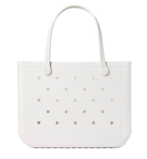 A white, rectangular Original Bogg® Bag tote from Bogg Bags features two handles and evenly spaced holes on the front. The brand name “bogg” is embossed on the lower right corner, making this washable bag a practical choice for your next beach tote.