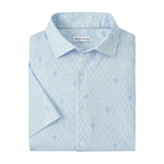 The Whitehaven Sport Shirt by Peter Millar is a featherweight, light blue short-sleeve button-up with a subtle white geometric pattern, neatly folded.