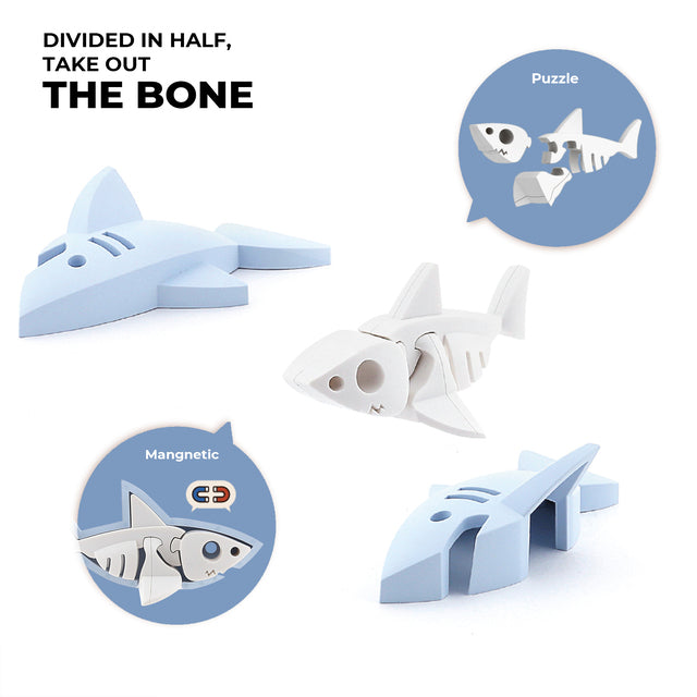 The Halftoys Ocean Friends, a plastic shark toy from Halftoys, can be split in half to reveal a skeleton-like bone structure. Labeled as an "animal puzzle," it features magnetic parts for easy reassembly, blending fun and education perfectly.