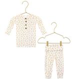Dress your little one in cozy comfort with the Lou Lou & Company Baby Girls’ and Girls’ Lottie Top & Bottoms. This adorable two-piece set features a long-sleeve, buttoned shirt and matching pants, both crafted from silky-soft fabric in white adorned with a charming small colorful floral print. Displayed on gold hangers, this outfit ensures all-day coziness and style.