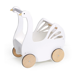 The Sweet Swan Pram by Tender Leaf Toys is a charming white wooden swan-shaped pushcart, featuring four light wooden wheels and elegant cut-out wing details on the sides—a delightful buggy or doll stroller that little ones will love.