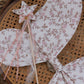 A Noralee Crown + Wand set, featuring a crown and matching wand, is displayed on a woven cane chair.