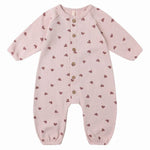 The Quincy Mae Baby Girls' Waffle Long Sleeve Jumpsuit features a light pink knit with brown heart print, front coconut buttons, and is shown on a plain white background.