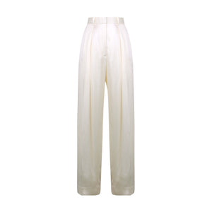The Victoria Beckham Wide Leg Trouser in ivory features a high waist, regular fit, front pleats, and satin-trimmed waistband, shown against a white background.