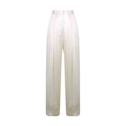 The Victoria Beckham Wide Leg Trouser in ivory features a high waist, regular fit, front pleats, and satin-trimmed waistband, shown against a white background.