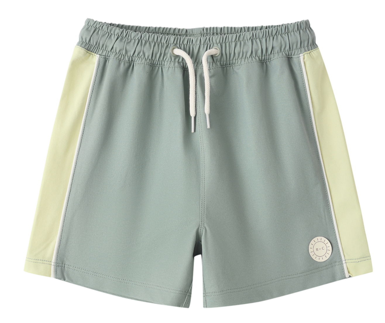 The Rylee & Cru Baby Boys' and Boys' Paneled Boardshort features light green fabric with off-white side panels, a white drawstring, elastic waistband, and a logo patch. Made with UPF 50+ fabric for added sun protection.