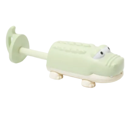 The Sunnylife Water Squirters is a light green and white plastic crocodile bath toy with a handle and cartoon eyes, ideal for outdoor waterplay, shown against a white background.
