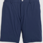 A pair of Johnnie-O Fusionn Shorts in plain navy blue chino style, featuring a button closure and belt loops, crafted from comfortable stretch-knit fabric and displayed against a light background.