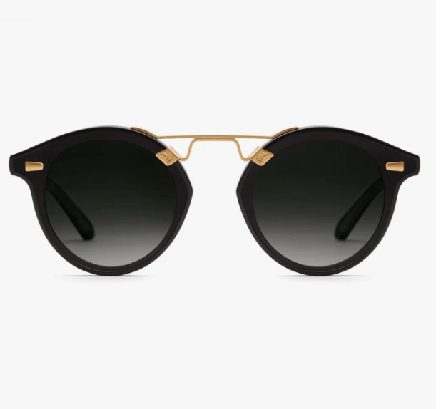 The STL Nylon Sunglasses by Krewe feature an oversized, black round design with dark nylon lenses and gold accents, including a distinct bridge, shown against a white background.