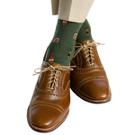 Brown leather brogue shoes with light-colored pants and Dapper Classics Pine Green Bourbon Bottles Mid Calf Socks.