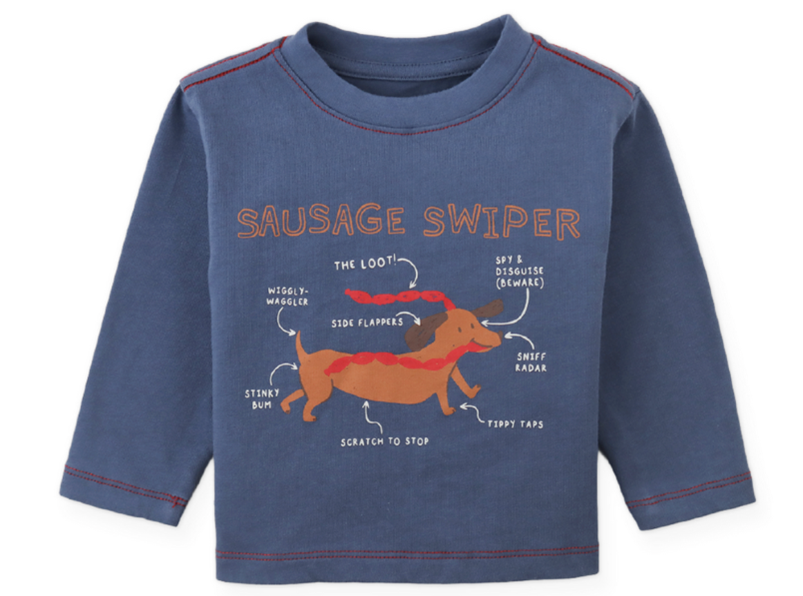 The Baby Boys’ Myron Graphic Tee from Gingersnaps is a blue long-sleeve t-shirt featuring a charming dachshund illustration with playful labeled features, text and arrows, and “Sausage Swiper” written above the embroidered outline of the cartoon pup.