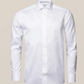 The Eton White Signature Twill Shirt in contemporary fit features a classic collar and front buttons. Set against a neutral background, its wrinkle-free fabric offers timeless elegance, making it an ideal wardrobe addition.