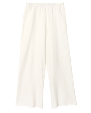 The Emmette Sweatpant by Xirena features a loose, wide-leg fit and elastic waistband, crafted from organic mineral wash terry and shown laid flat against a white background.