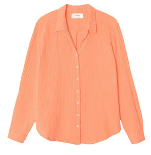The Xirena Scout Shirt—a long-sleeve, button-up in light coral by Xirena—lays flat to display its textured gauze fabric and classic collar, making it a go-to for effortless style.