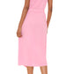 A person is shown from the back against a white background wearing the Xirena Aliza Dress, a belted, short-sleeve pink button-front midi dress, paired with black sandals featuring beige laces.