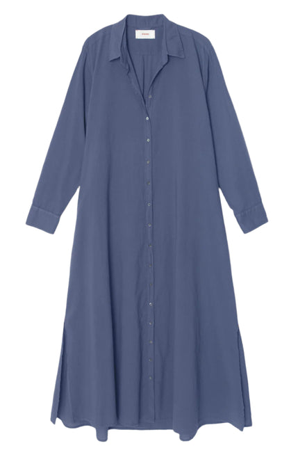 The Xirena Boden Dress is a solid blue, long-sleeve, collared button-front dress made from woven cotton poplin with side slits and a relaxed fit.