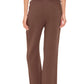 A person is shown from the back wearing a white top, tan sandals, and Xirena's Ozzie Pant—a cropped pull-on style with an elasticized drawstring waist.