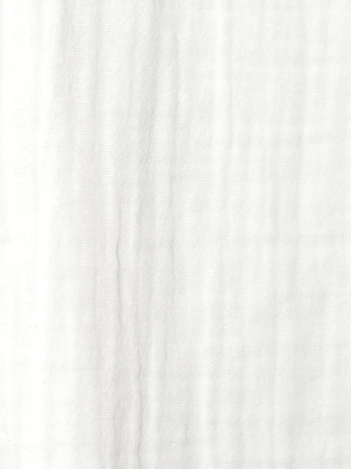 Close-up of the Evelyn Skirt by Xirena—crafted from white, textured cotton gauze with subtle vertical lines and a soft, airy feel. Ideal for a relaxed, pull-on A-line silhouette.