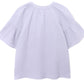 The Nia Top by Xirena is a loose-fitting, light purple cotton gauze popover with a round neckline, gathered shoulder detailing, and flutter sleeves, shown against a white background.
