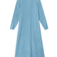 The Tabitha Dress by Xirena is a light blue cotton gauze midi with long sleeves and ankle length, shown flat from the back against a white background.
