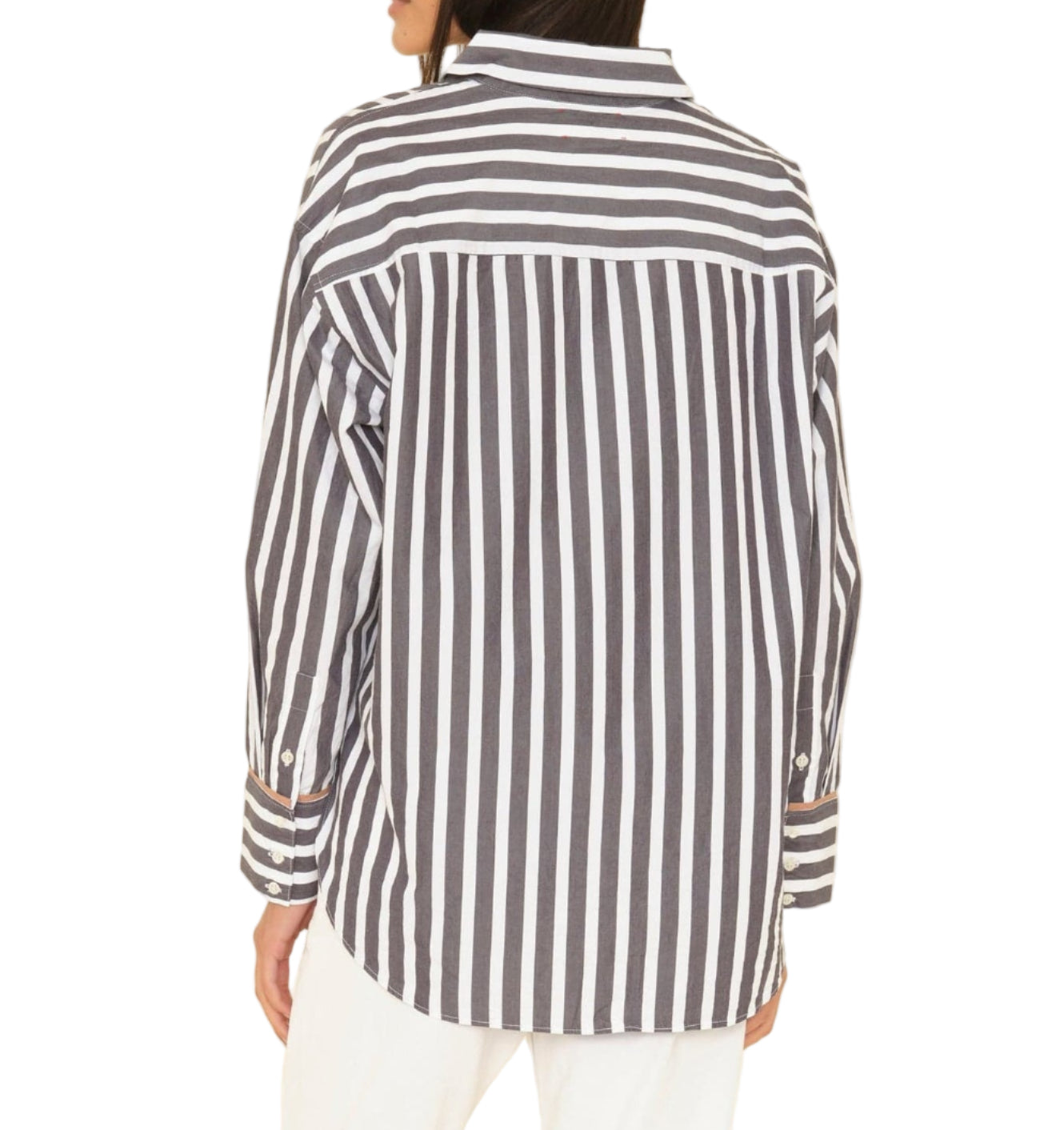 A person is shown from the back wearing the Xirena Gillian Shirt, a relaxed, black and white vertically striped button-front shirt.