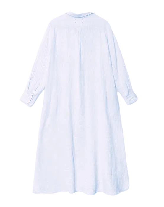The Xirena Boden Gauze Dress is a long-sleeved, ankle-length, light blue cotton shirtdress with a relaxed fit, shown from the back against a white background.