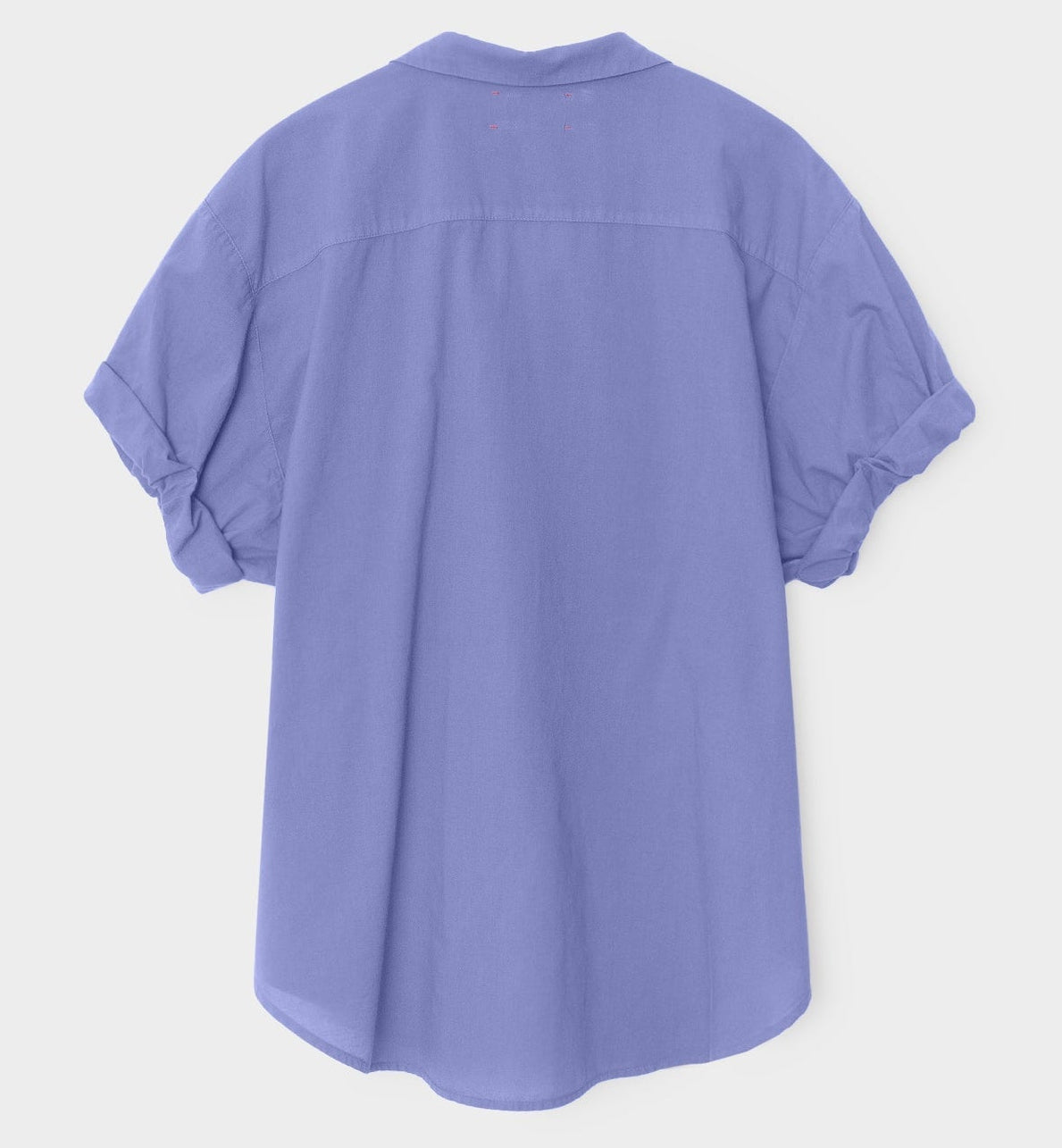 The Xirena Channing Cotton Poplin Shirt in light purple is shown from the back, featuring rolled-up sleeves, against a plain white background.