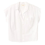 The Lexi Shirt by Xirena is a lightweight cotton, button-front shirt featuring short sleeves, a front chest pocket, spread collar, and a relaxed fit, shown on a plain white background.