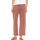 A person shown from the back wears a white top, Xirena Matteo Sweatpant—vintage washed French terry, wide-leg, rose-colored cropped ankle-length sweatpants with back pockets—and brown sandals.