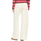 A person is shown from the back against a plain white background wearing the Xirena Renzo Sweatpant in white, featuring a wide-leg silhouette and an elasticized drawstring waist, paired with brown shoes and a pink and brown striped long-sleeve top.