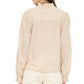 A person shown from the back wearing the Dorien Top by Xirena, a long-sleeve beige blouse featuring blouson sleeves and a ruffled collar, paired with cream pants.