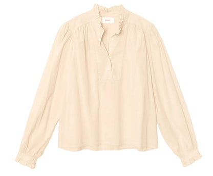 The Dorien Top by Xirena is a cream-colored, long-sleeve blouse crafted from lightweight cotton poplin, featuring a delicate ruffled collar, partial button front, and gathered blouson sleeves. It is displayed on a plain white background.