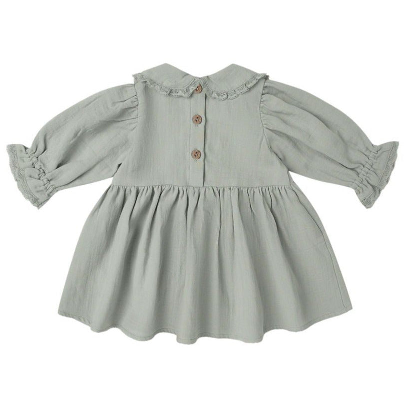 The Quincy Mae Baby Girls' and Girls' Marisol Dress features light grey fabric, a gathered skirt, wooden back buttons, and lace ruffle trim on the collar and sleeves.