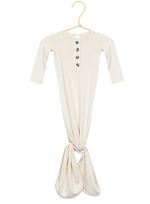 The Lou Lou & Company Baby Dakota Plush Knit Knotted Gown features a cream color, long sleeves, a button-down front, and a convenient knotted tie bottom for hassle-free diaper changes. It is displayed on a gold hanger against a white background.