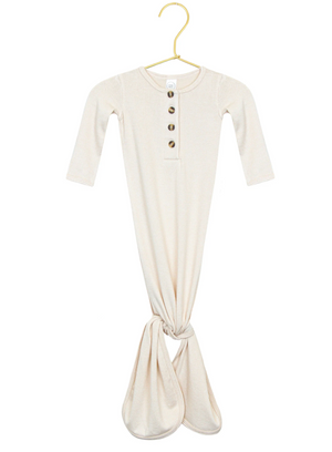 The Lou Lou & Company Baby Dakota Plush Knit Knotted Gown features a cream color, long sleeves, a button-down front, and a convenient knotted tie bottom for hassle-free diaper changes. It is displayed on a gold hanger against a white background.