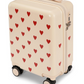 Cream-colored Konges Slojd Kids’ Travel Suitcase with a red heart pattern, featuring a top handle and a side TSA lock.