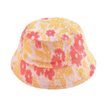 The Lajik Hat by Louise Misha is a jacquard sun hat with textured fabric featuring a yellow and orange floral pattern on a light background.