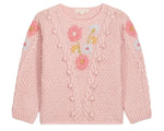 The Girls’ Acacia Sweater by Louise Misha is a light pink knit adorned with textured patterns and delicate handmade embroidery in shades of pink, blue, and yellow across the chest and sleeves, finished with playful pom-pom accents, displayed against a white background.