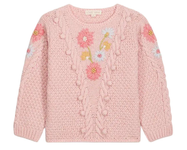 The Girls’ Acacia Sweater by Louise Misha is a light pink knit adorned with textured patterns and delicate handmade embroidery in shades of pink, blue, and yellow across the chest and sleeves, finished with playful pom-pom accents, displayed against a white background.