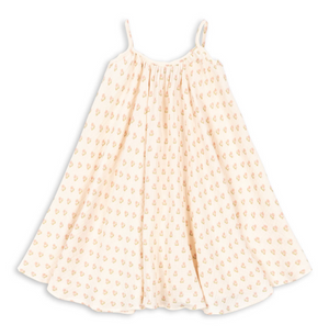 The Girls’ Coco Strap Dress by Konges Slojd is a cream-colored muslin summer dress with thin shoulder straps and a flared silhouette, featuring a soft feel and a small, repeating yellow and pink floral pattern.
