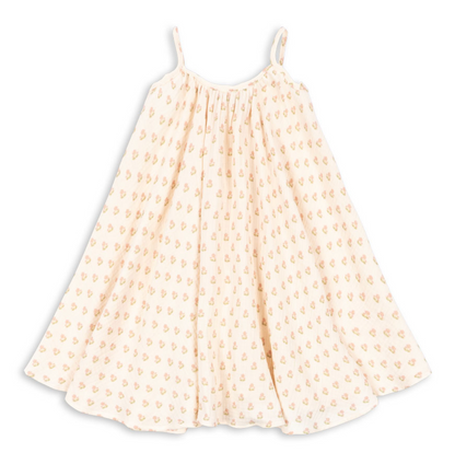 The Girls’ Coco Strap Dress by Konges Slojd is a cream-colored muslin summer dress with thin shoulder straps and a flared silhouette, featuring a soft feel and a small, repeating yellow and pink floral pattern.