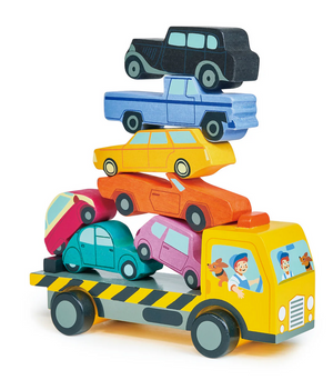 The Tender Leaf Toys Stacking Cars set features a wooden toy truck with six colorful wooden cars stacked on its flatbed; a painted driver and dog can be seen in the cab, making it a delightful balancing game that encourages fine motor skills.