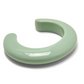 The Ridge Cuff by Lizzie Fortunato is a glossy, light green, C-shaped ceramic bracelet with a thick, smooth form, shown against a white background.