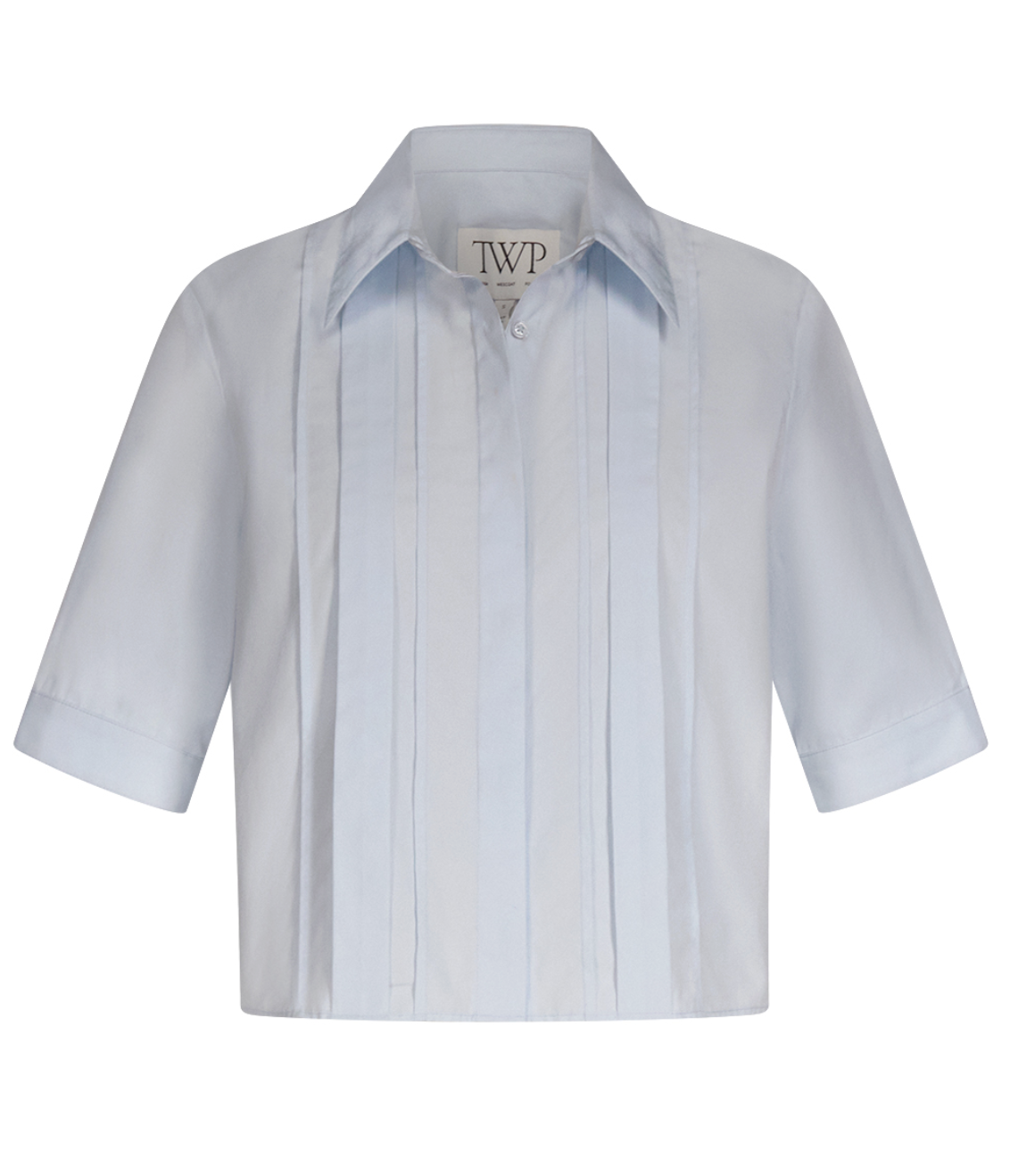The Short Lived Cherry Pleat Top by TWP is a light blue cropped button-down shirt with a collar and vertical pintuck detailing, shown against a plain white background.